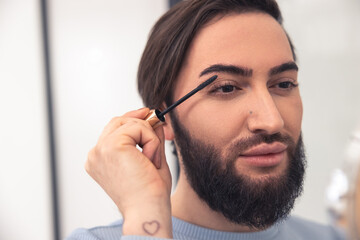 Male involved in the eye makeup application