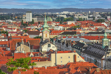 Fototapeta na wymiar Graz, Austria - July 12th, 2021: Beautiful panoramic view to the old town of Graz, popular travel destination in Austria