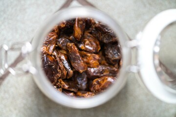 dried fruit, dates, prunes, grains, wheat, lentils, rice stored in glass jars in a kitchen
