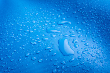 Blue waterproof material with waterdrops.  Close-up Photo of Water Drops. 