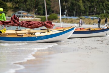 man watching wooden boat on the water, at the wooden boat festival in hobart tasmania australia