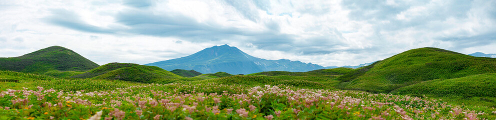 Mountain landscape at Paramushir Island, Green meadows with beautiful mountain views. Kuril Islands, Russia.
