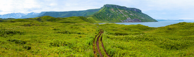 Mountain landscape at Paramushir Island, Green meadows with beautiful mountain views. Kuril Islands, Russia. - 569533775