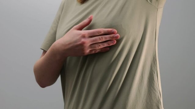 Breast cancer self-check. Hand examining, palpating chest for tumors, lumps, fibroadenoma. Women health awareness day