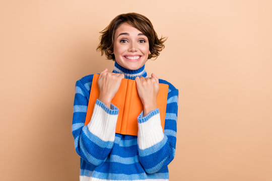 Photo of pretty excited woman dressed striped sweater reading interesting book empty space isolated beige color background