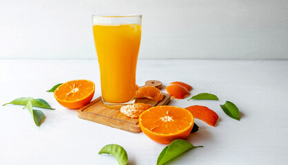 Orange juice and fresh orange fruits On a white wooden background