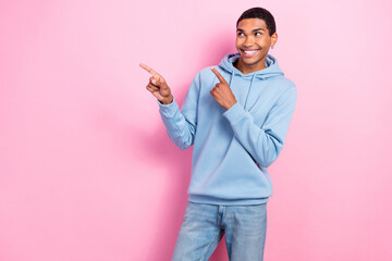 Photo of positive guy toothy smile look direct fingers empty space news isolated on pink color background