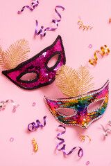 Festive face mask for carnival celebration on colored background