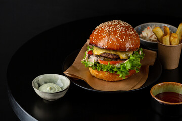 Tasty burger  with sauce fast food top view on black table