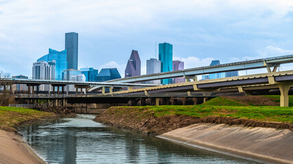Fototapeta na wymiar Houston Downtown City Skyline and water reflections along the White Oak Bayou Greenway under Interstate 45 Freeway in Texas, USA