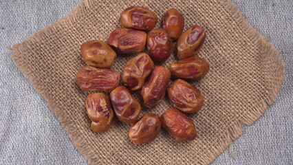 Dates in wooden bowl on background. dried dates fruit.