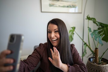 Girl video calling her friends on a zoom call. Woman on holiday skyping her family outside in a...