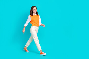 Fototapeta na wymiar Full body length photo of positive successful project manager office worker wear stylish uniform walk mockup isolated on cyan color background