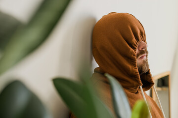 Depressed unhappy man covered hood her face - escapism and loneliness mental problem concept....