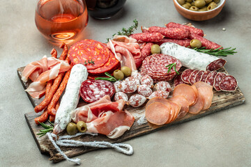 Antipasto meat board. catering platter with bacon, jamon, sausage and wine. Food recipe background. Close up