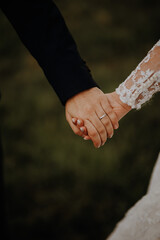 Bride and groom holds their hands