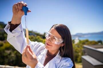 soil scientist agronomist farmer looking at soil samples and grass in a field in spring. looking at growth of plants and soil health