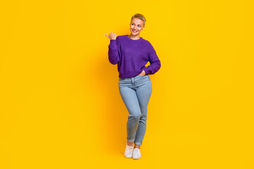 Fototapeta na wymiar Full size portrait of positive charming girl look direct thumb finger empty space isolated on yellow color background