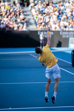 crowds watching a female Professional athlete Tennis player playing on a court in a tennis tournament in summer in australia