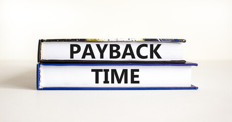 Payback time symbol. Concept words Payback time on books. Beautiful white table white background. Business and payback time concept. Copy space.