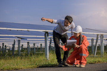 Electrical, instrument technician survey, checking, maintenance electric system at solar panel field in sunny day.