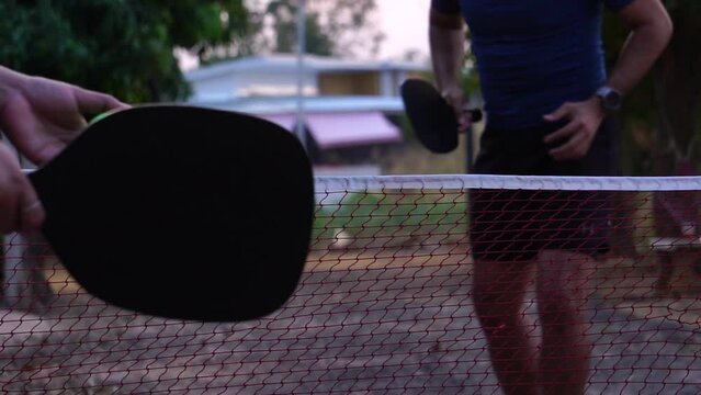 Senior Man Adults Playing Pickleball On An Outdoor Court