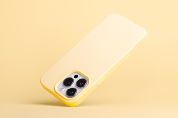 silver iPhone 13 and 14 Pro Max in yellow banana soft silicone case falls down back view, phone...