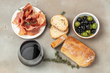 Bread ciabatta, jamon ham serrano paleta iberica, olives. Italian food ingredients, Restaurant menu, dieting, cookbook recipe top view