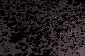 Wet black paper in drops of water