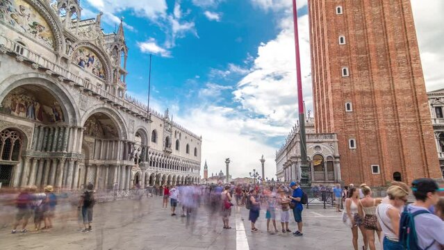Basilica of St Mark timelapse hyperlapse and San Marco campanile. It is cathedral church of Roman Catholic Archdiocese of Venice. Piazza San Marco. Tourists walking in front of it. Venice, Italy