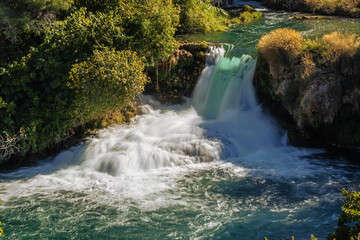 Fototapeta na wymiar A small waterfall on the Krka river in the Krka National Park