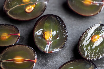 sweet ripe black grapes cut in half