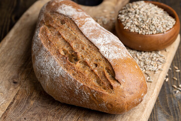 A whole freshly baked loaf of dark bread