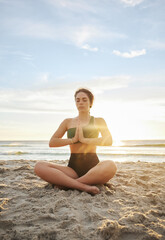 Fototapeta na wymiar Woman, yoga and meditation on the beach in namaste for spiritual wellness or zen workout in the sunset. Female yogi relaxing and meditating for calm, peaceful mind or awareness by the ocean coast