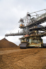 An huge excavator on a coal surface mine. Interesting geological forms of tailings dump in an open pit coal mine.