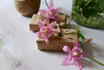 Pink and blue flowers, postcard, kraft, twine. Layout of Women's Day or Mother's Day, St. Valentine's Day, flat, top view.