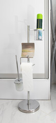 Modern chrome stand for toilet paper and air freshener.