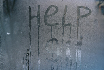 911 help inscription on wet glass