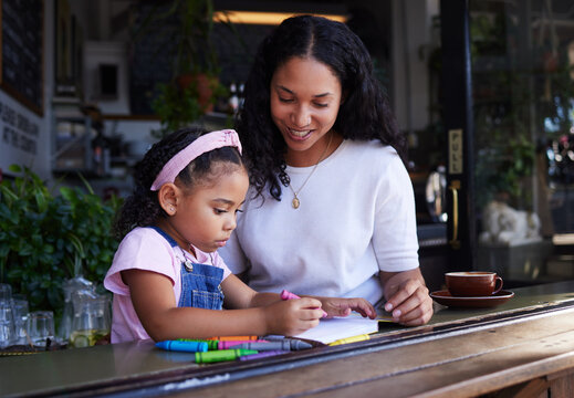 Art, drawing and mother and child at a restaurant with an activity, creativity and color on paper. Creative, happy and girl learning to draw with her mom while eating at a cafe and waiting for food
