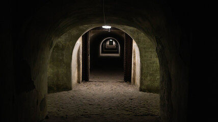 Underground protective structures in the form of military bomb shelter tunnels. Catacombs in the fortress. Fortification, background