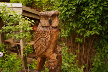 Wooden figure of an owl in the forest