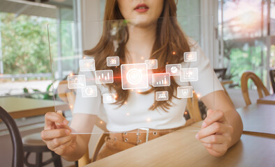 Businesswoman holding digital tablet with futuristic design for big data analytics and business intelligence concept with chart and graph icons. Technology and people in life style. Digital screen.