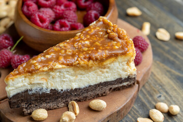 Cheesecake with chocolate sponge cake and peanuts in caramel