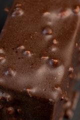 Fresh sweet cake with milk taste and aroma in chocolate glaze