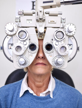 Senior woman patient, eye test and phoropter in hospital, optometrist office or clinic for vision healthcare. Optician tools, elderly lady or medical lens device for customer, client or consumer eyes