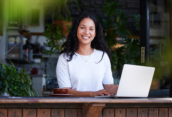 Cafe, portrait and woman typing on laptop for online project, email or sales report. Freelancer,...