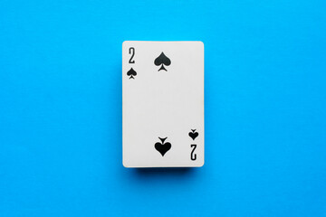 Playing card deuce of spades on a blue background