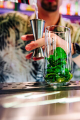 bartender preparing mojito cocktail drink in bar