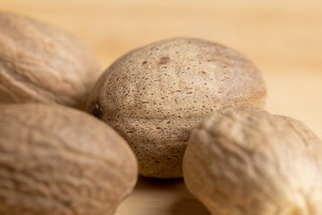 A whole nutmeg fruit on the kitchen table