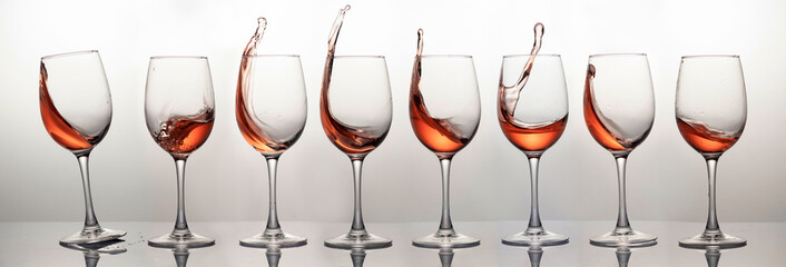 Splash of rose wine in glass, frozen motion